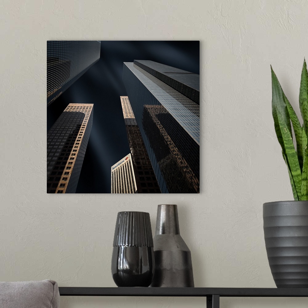 A modern room featuring Looking up at geometric skyscrapers against a dark sky.