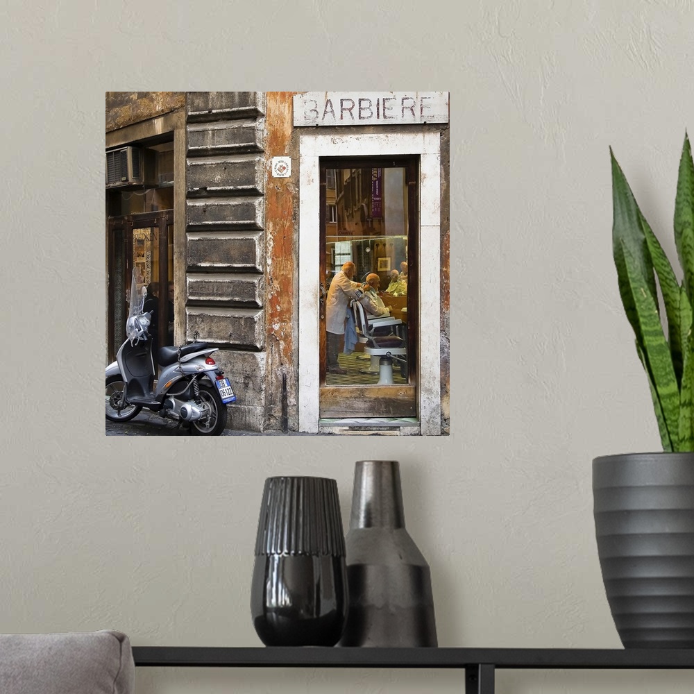 A modern room featuring A scooter outside of a barbershop in Italy.