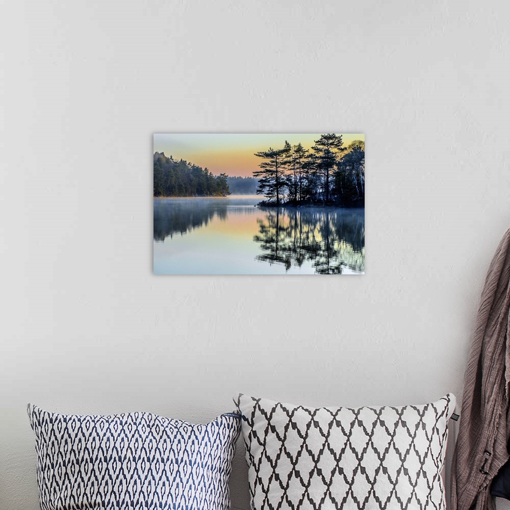 A bohemian room featuring Pastel rainbow sky over a lake in the early morning in Sweden.