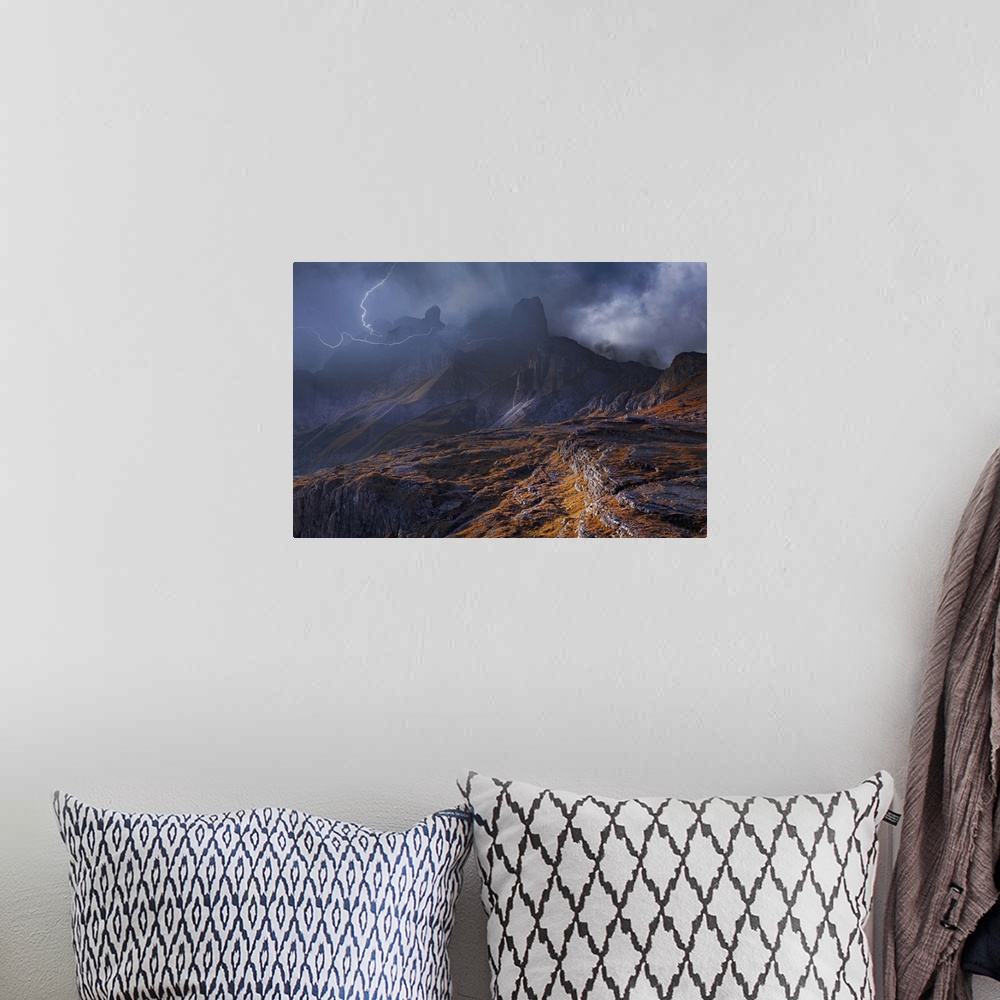 A bohemian room featuring Fog shrouded mountainous landscape surrounded by striking lightning.