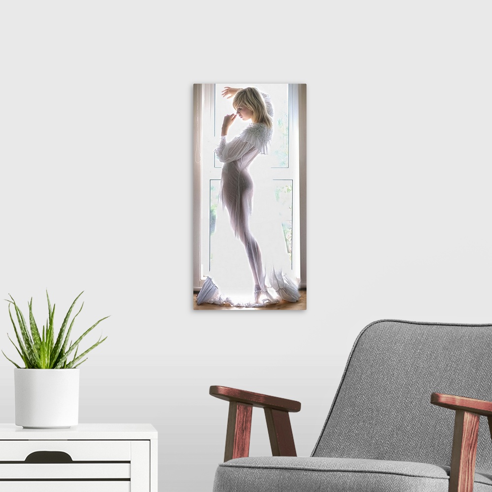 A modern room featuring Portrait of a beautiful young woman in a sheer nightgown standing in front of a window.