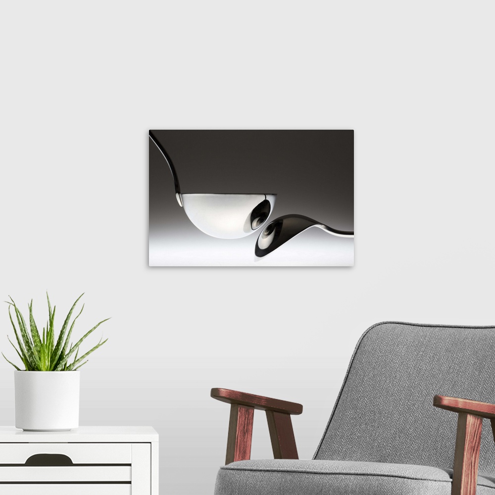 A modern room featuring A spoon is reflected in a metal ladle, resembling a pair of eyes.