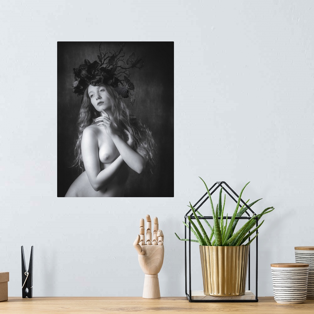 A bohemian room featuring Black and white fine art portrait of a nude woman wearing a floral and butterfly headpiece.