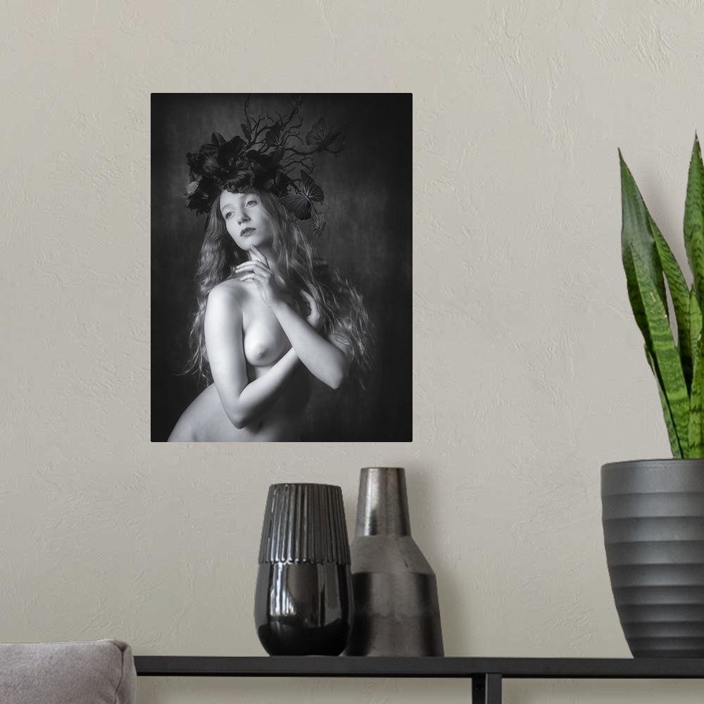 A modern room featuring Black and white fine art portrait of a nude woman wearing a floral and butterfly headpiece.