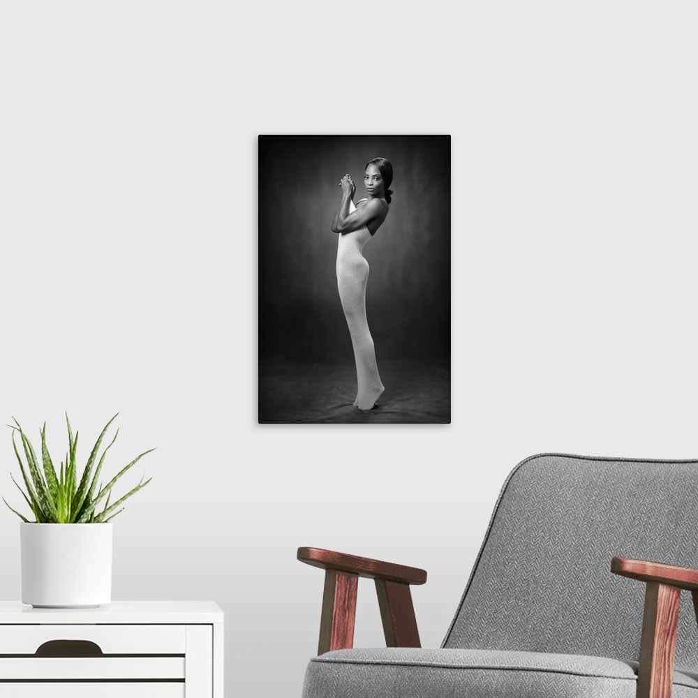 A modern room featuring Elegant black and white photograph of a nude woman wearing a tight body sock.