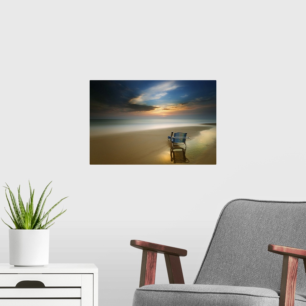 A modern room featuring Long exposure seascape photograph of a beach chair on the shore during sunset.