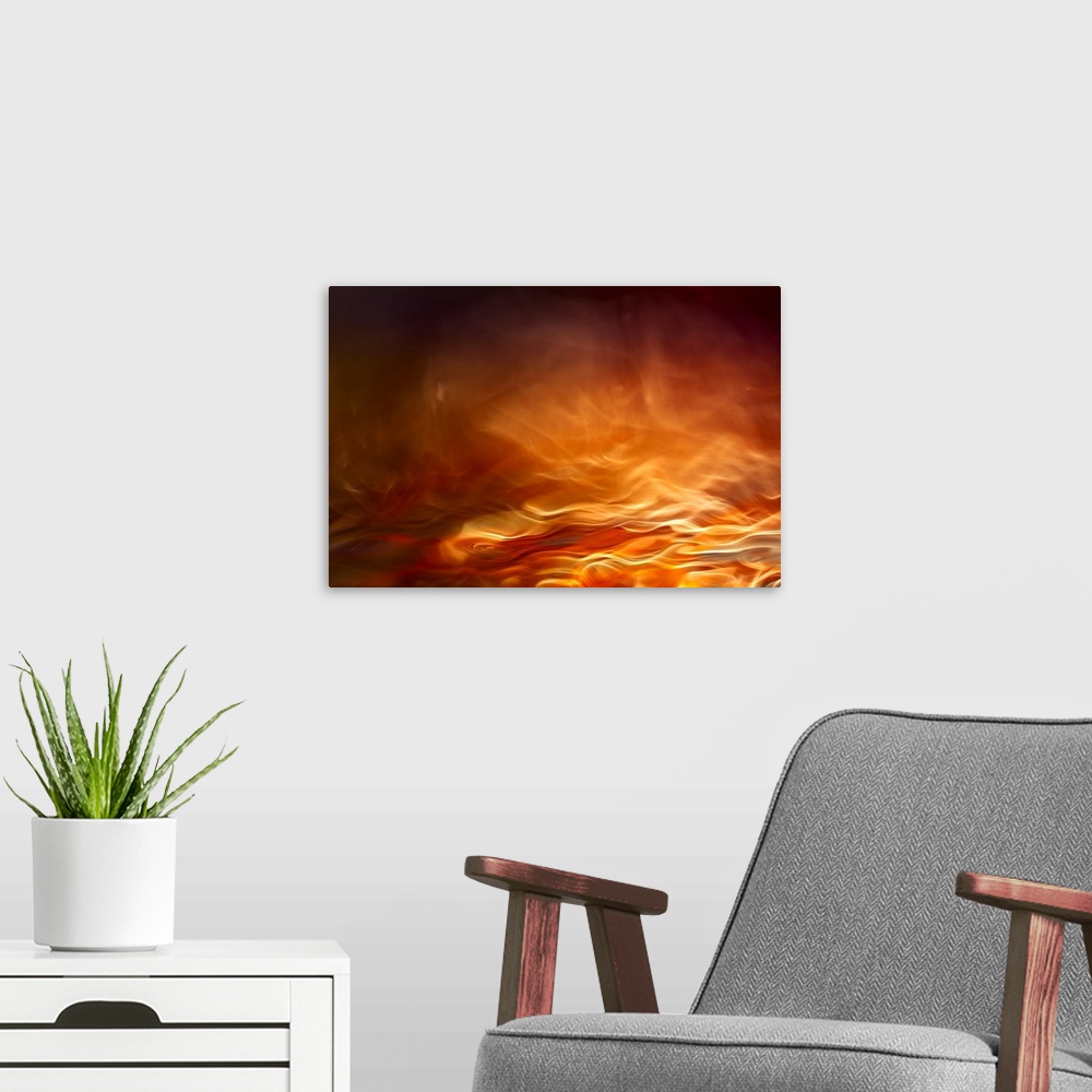 A modern room featuring Abstract digital art with orange, yellow, and red hues resembling water on fire.