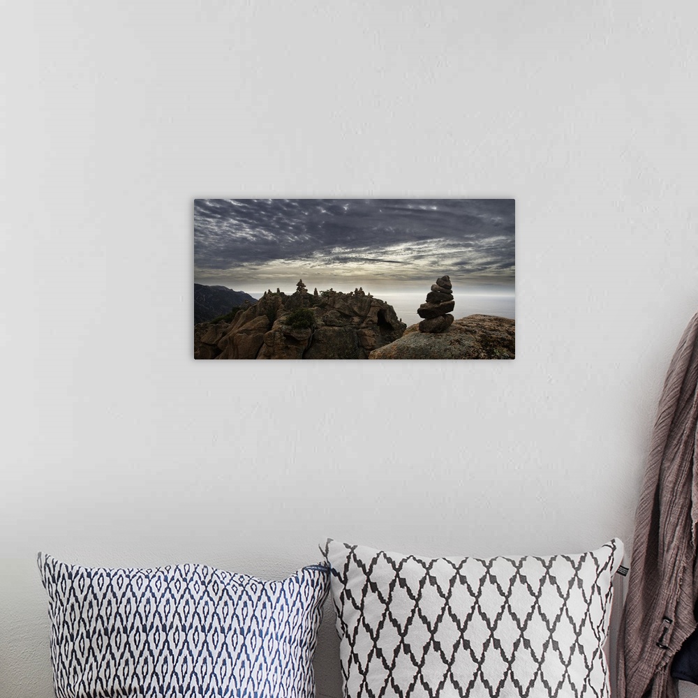 A bohemian room featuring Rocky cliff landscape under a blanket of smooth looking clouds.
