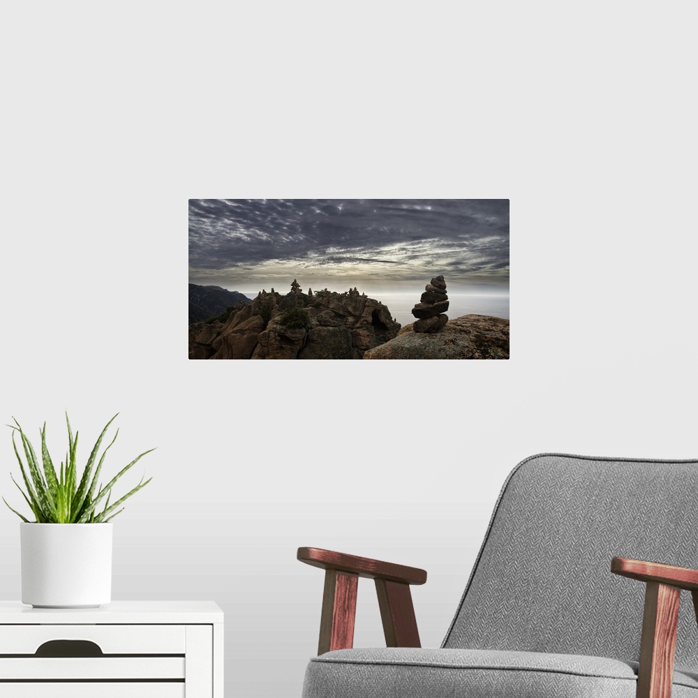 A modern room featuring Rocky cliff landscape under a blanket of smooth looking clouds.