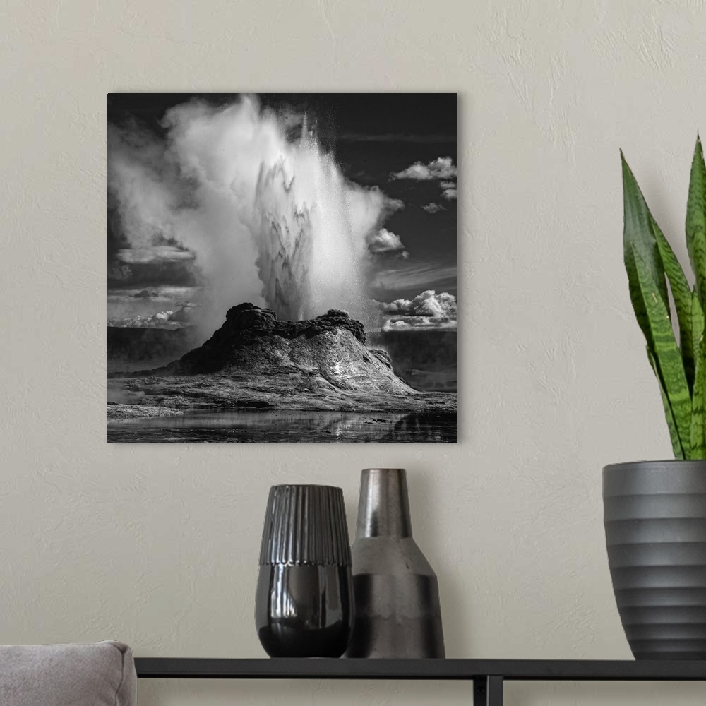 A modern room featuring An erupting geyser spewing water and steam into the air, Yellowstone, Wyoming.