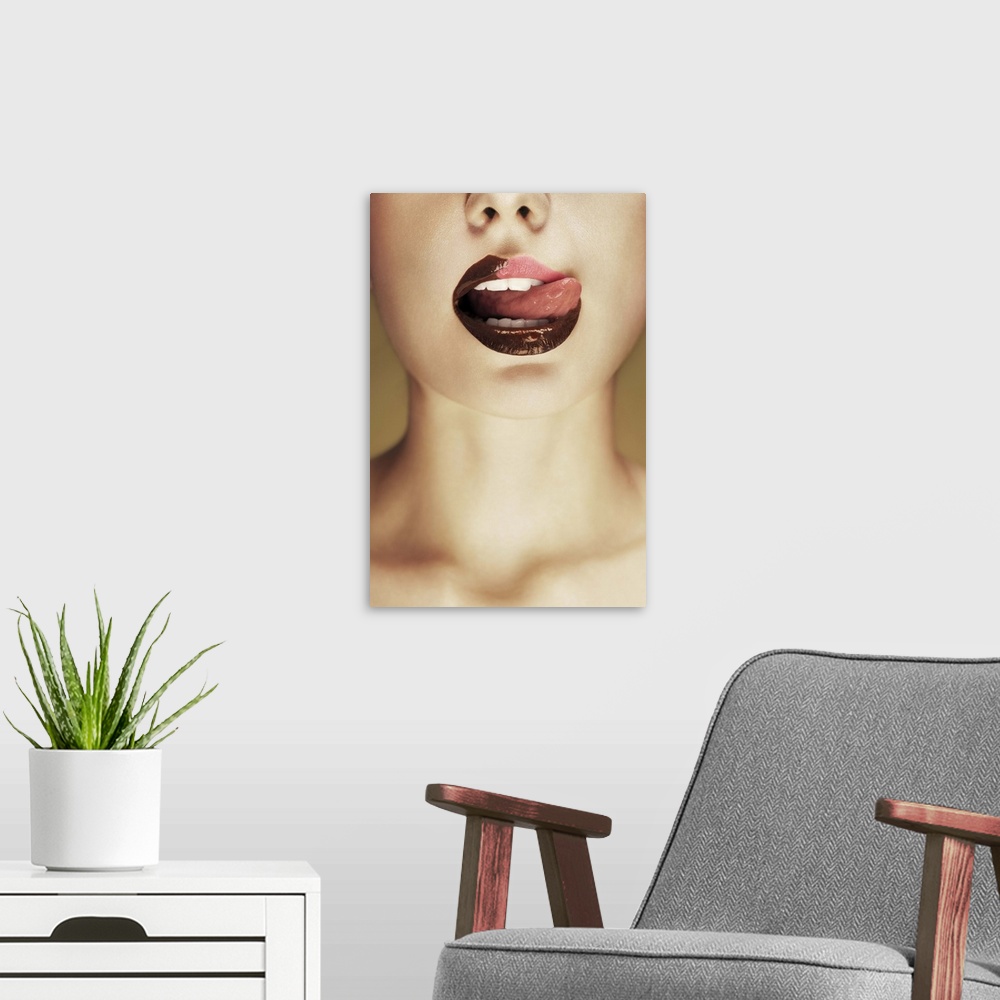 A modern room featuring A woman licking chocolate off of her lips with her tongue.