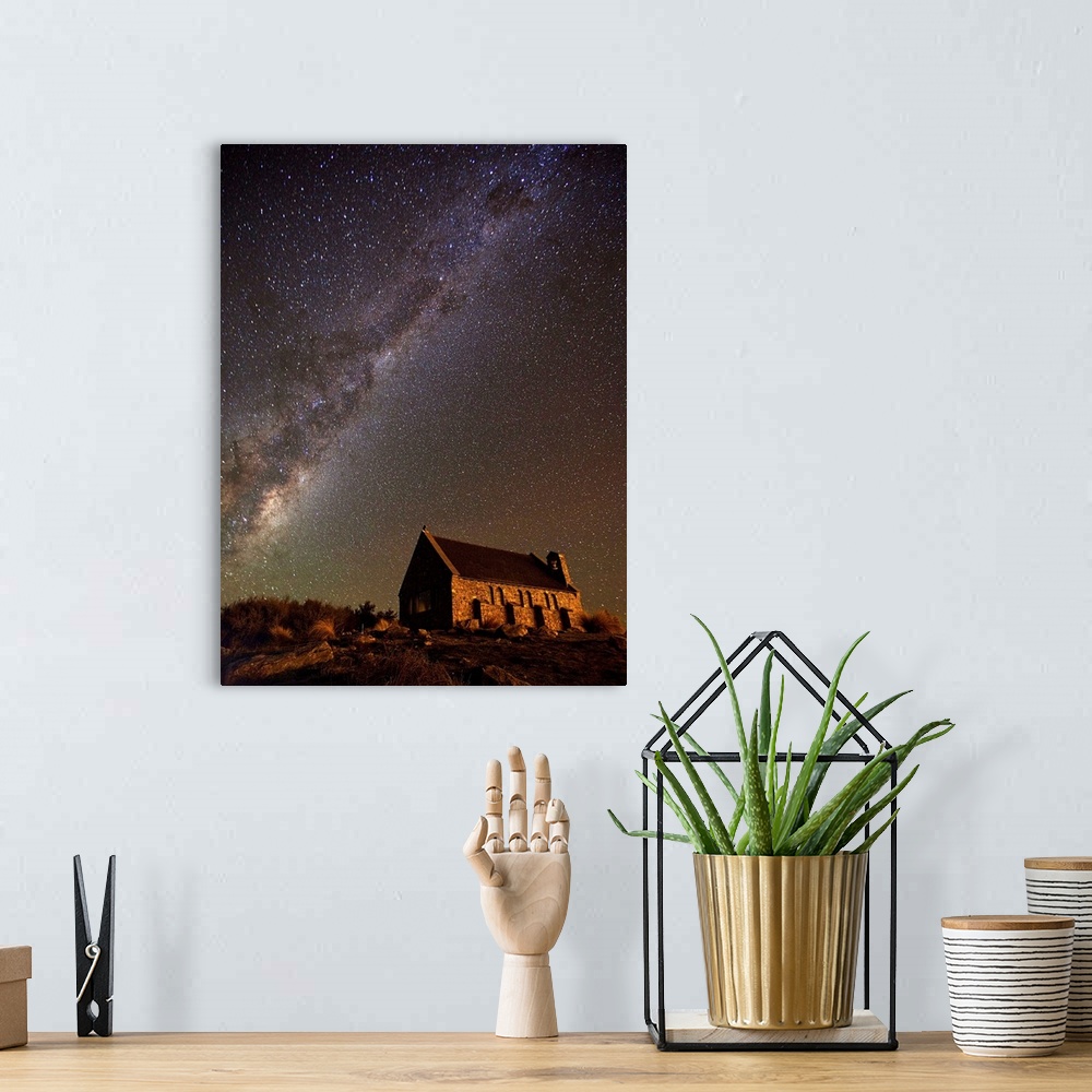 A bohemian room featuring An old church near Lake Tekapo in New Zealand, under a starry night sky.