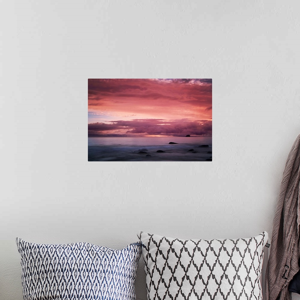 A bohemian room featuring A warm sunset over seascape in New Zealand.