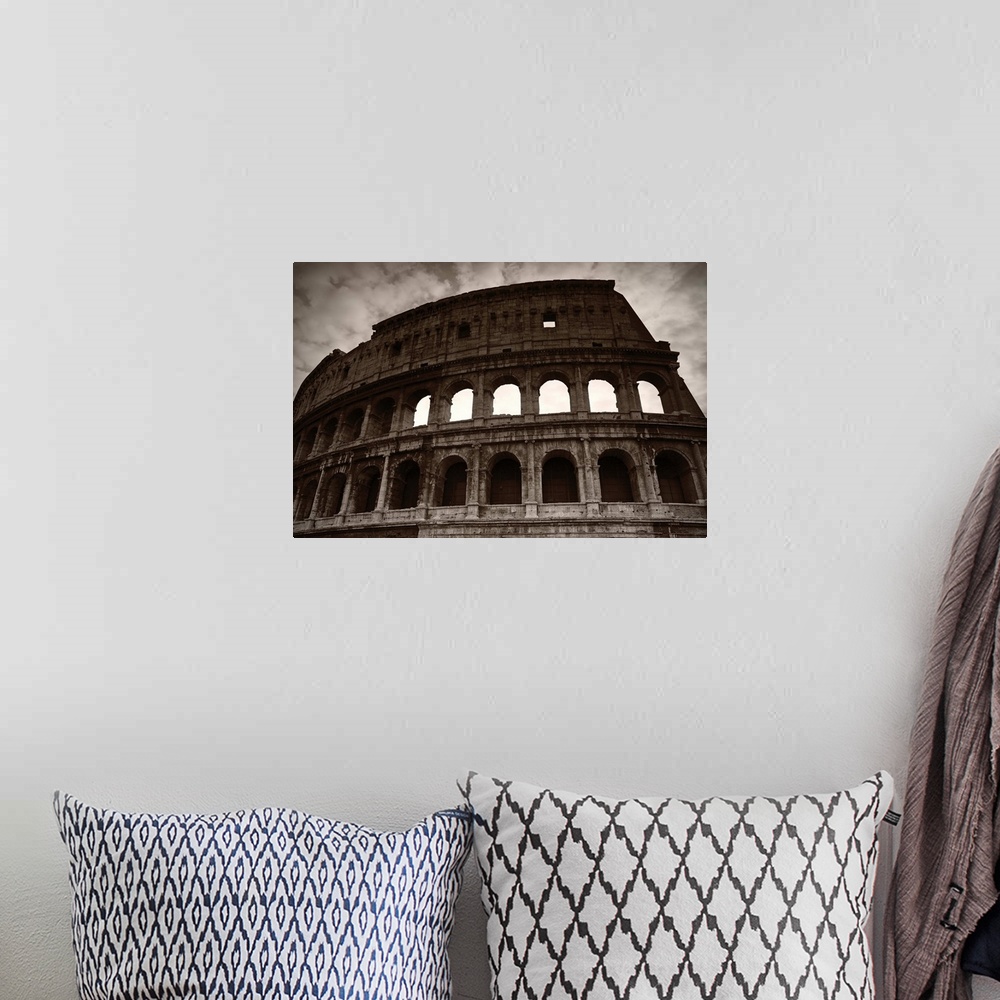 A bohemian room featuring Sepia photograph of the Colosseum in Rome on a cloudy day.