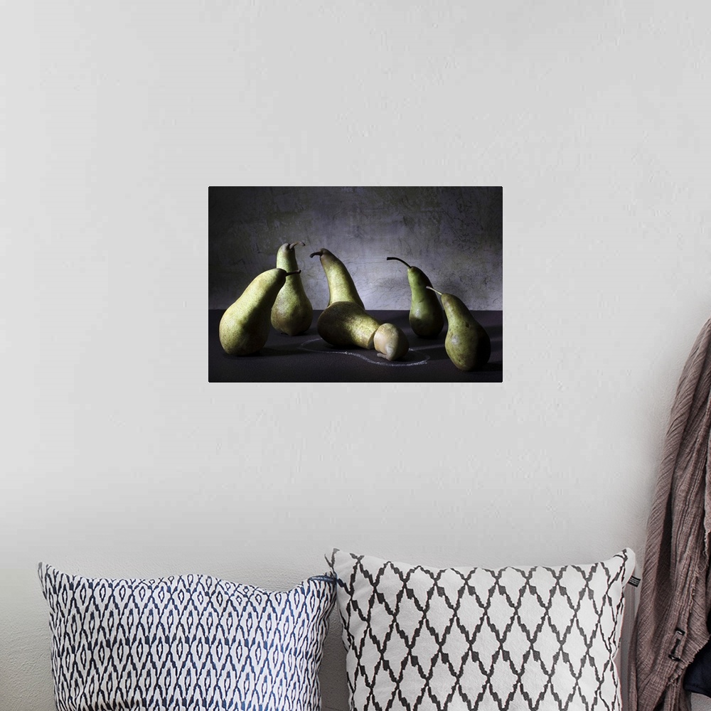 A bohemian room featuring Conceptual image of a group of pears appearing concerned over a sliced pear on the ground.
