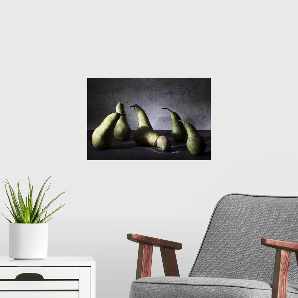 A modern room featuring Conceptual image of a group of pears appearing concerned over a sliced pear on the ground.