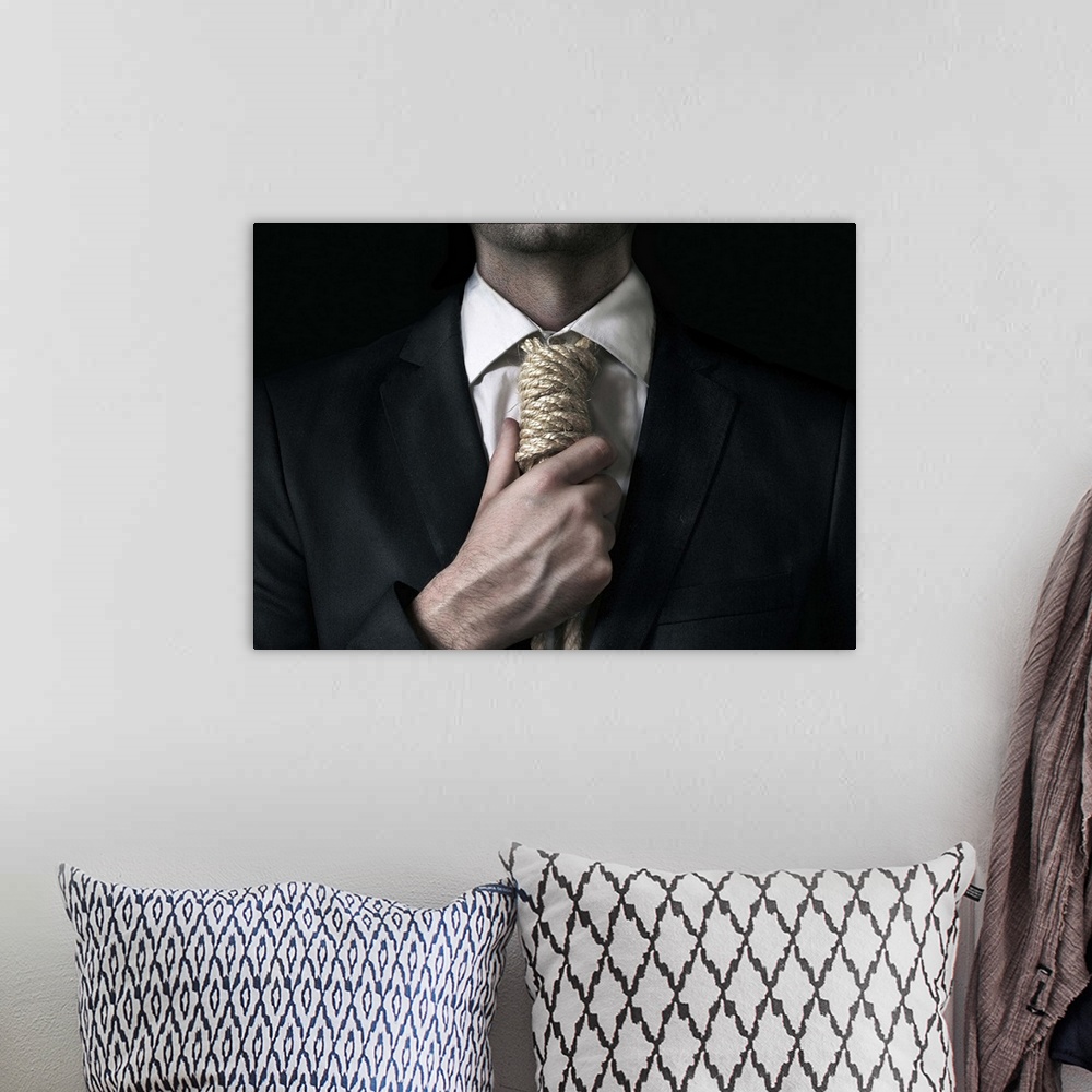 A bohemian room featuring Conceptual image of a man tightening a noose instead of a tie around his neck.
