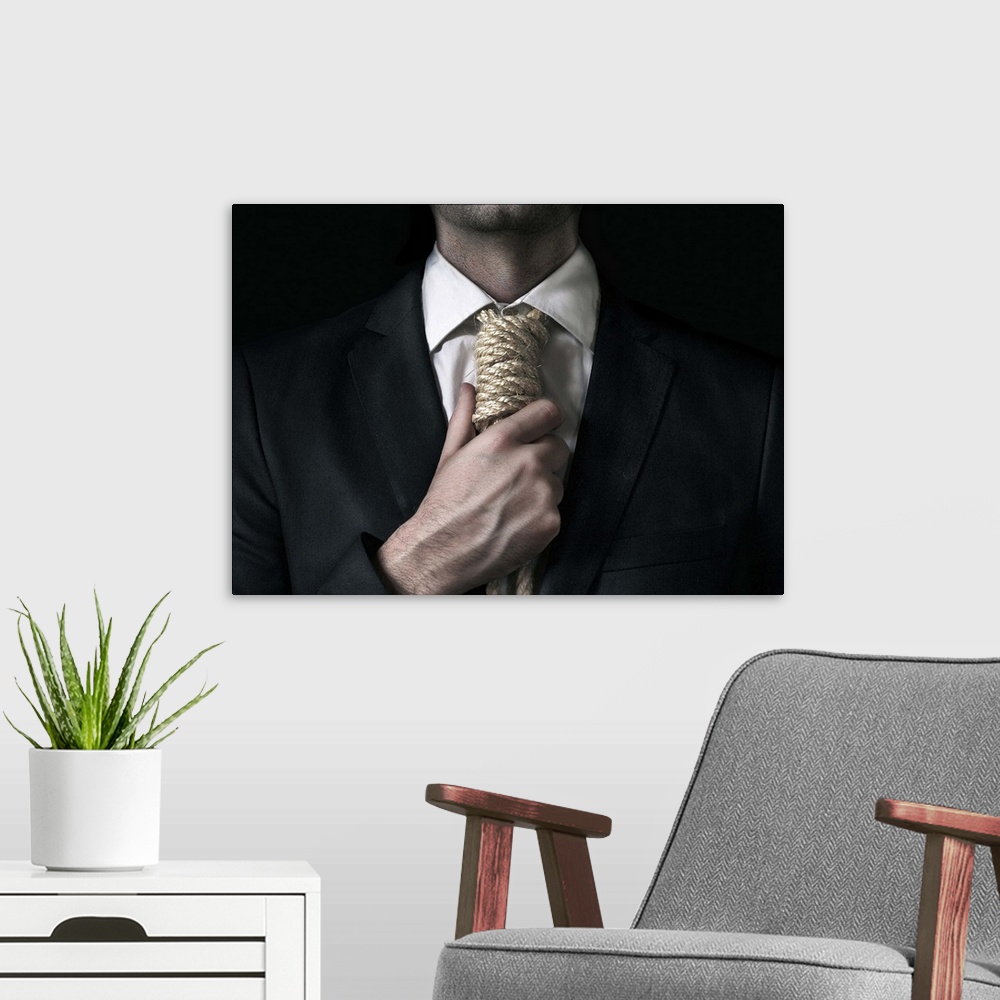 A modern room featuring Conceptual image of a man tightening a noose instead of a tie around his neck.