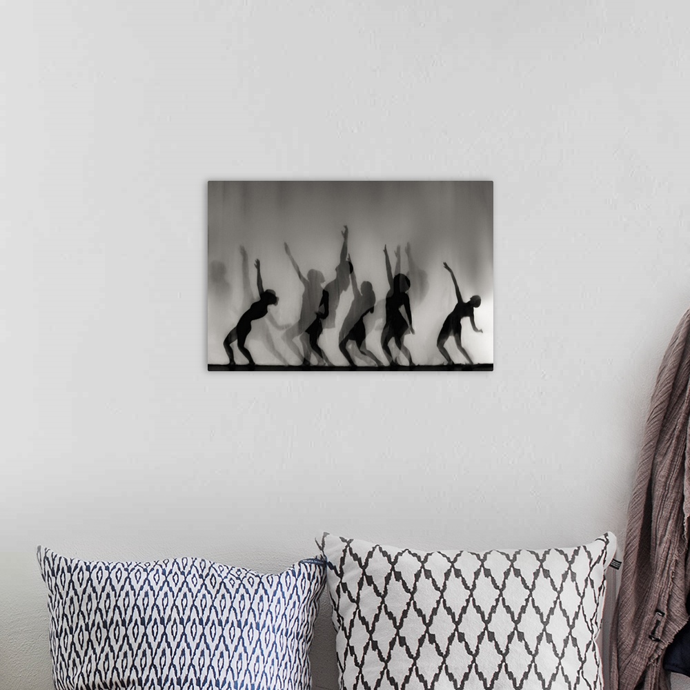 A bohemian room featuring Silhouettes of female forms in dancing positions.