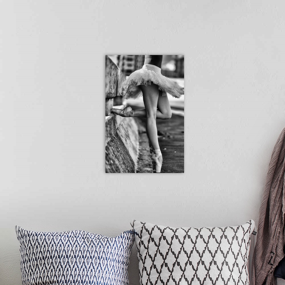 A bohemian room featuring A black and white photograph of a ballerina in a dancers pose leaning against a road divider outd...