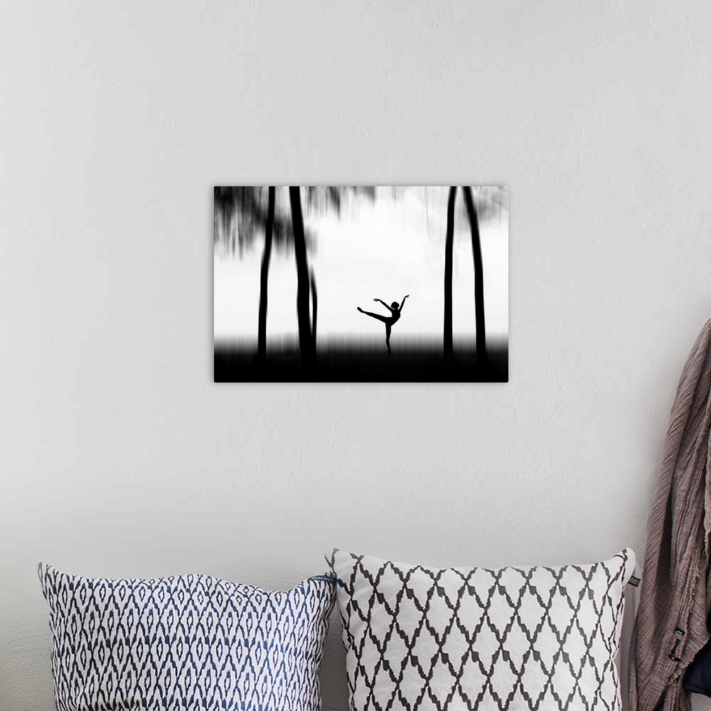 A bohemian room featuring Silhouette of a dancer posing between tall trees.