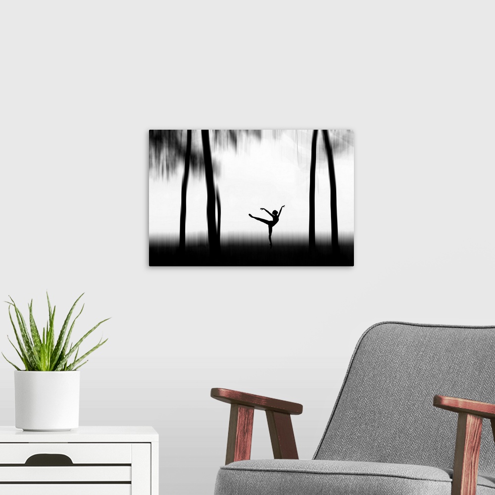 A modern room featuring Silhouette of a dancer posing between tall trees.