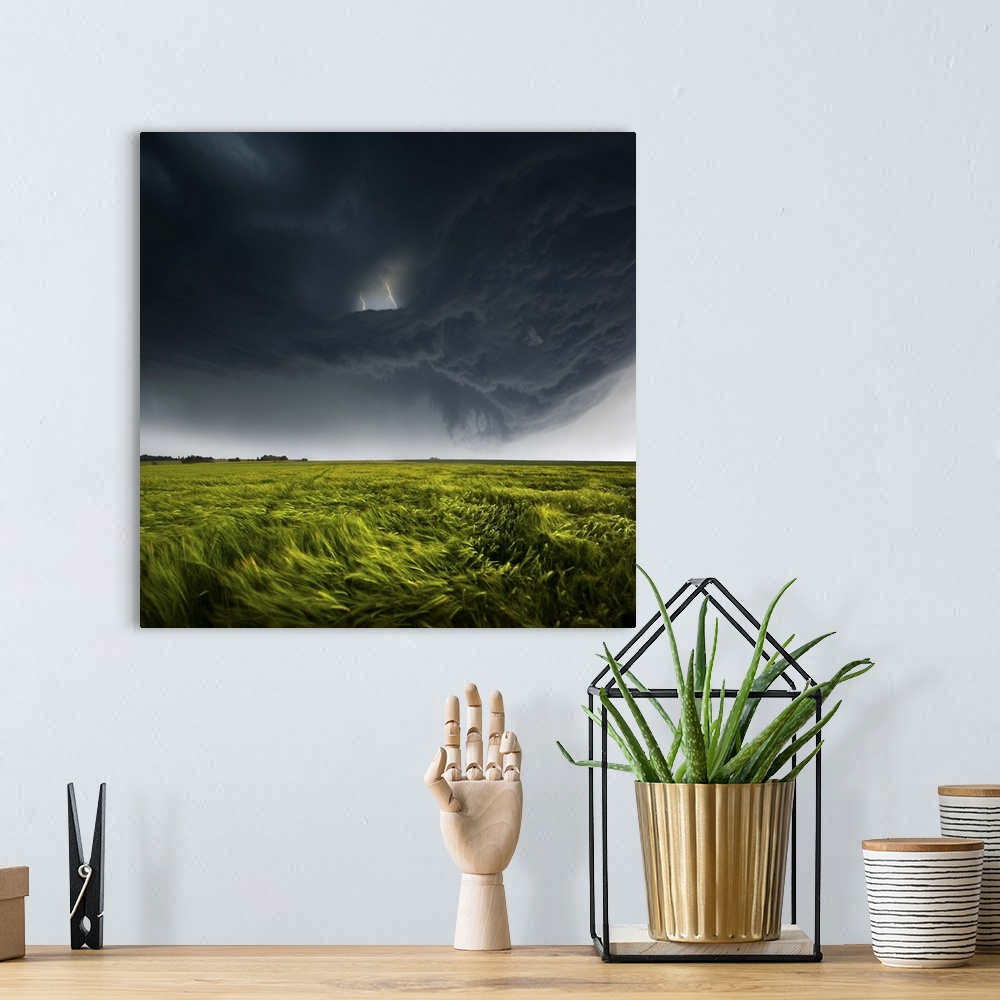 A bohemian room featuring Menacing dark clouds producing lightning over a green field in the countryside of Germany.