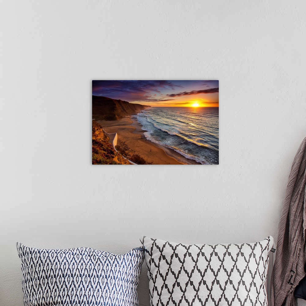 A bohemian room featuring Warm landscape photograph of the sunset in Praia Do Magoito, Portugal.
