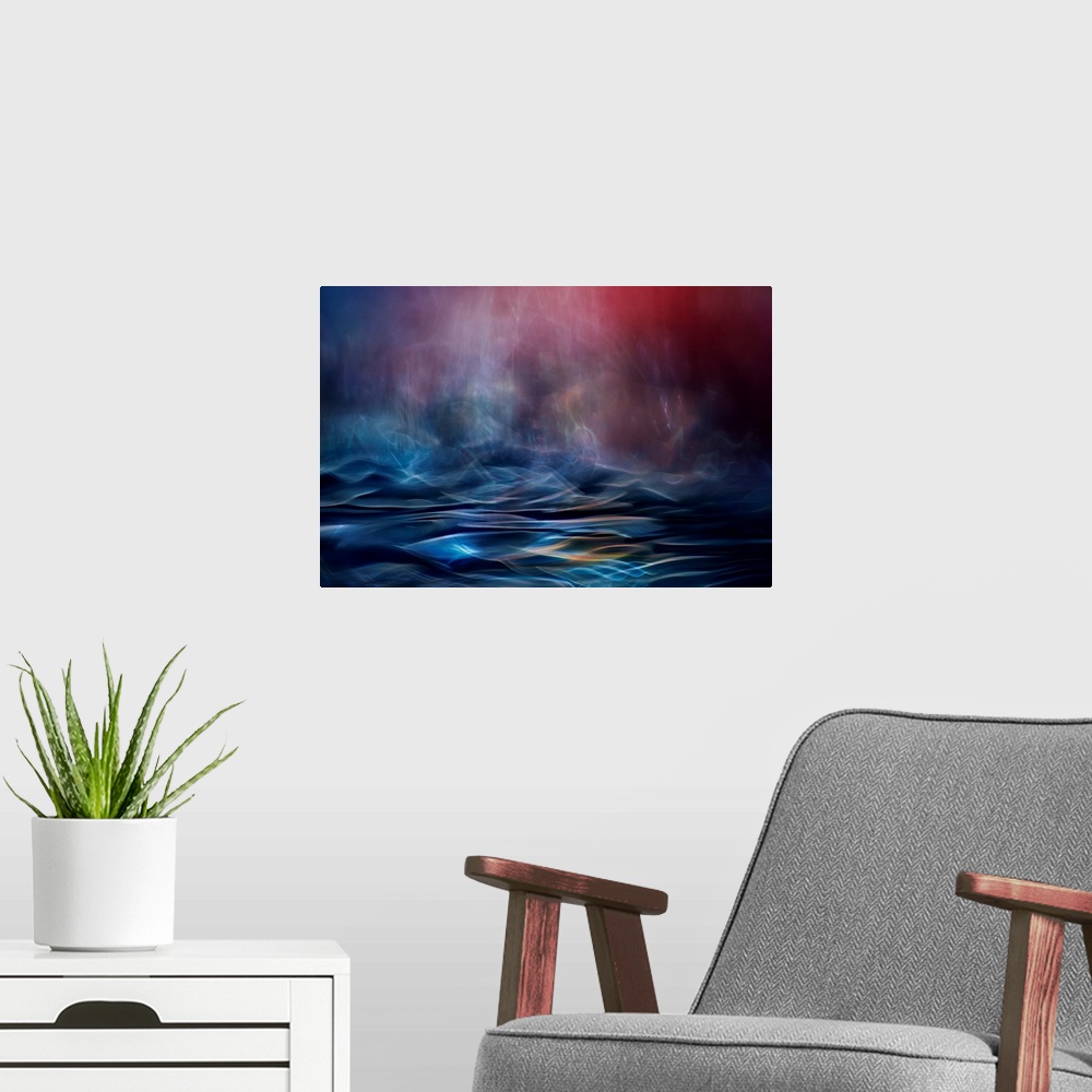 A modern room featuring Abstract image made of blurred light and color, resembling an ocean in the evening.