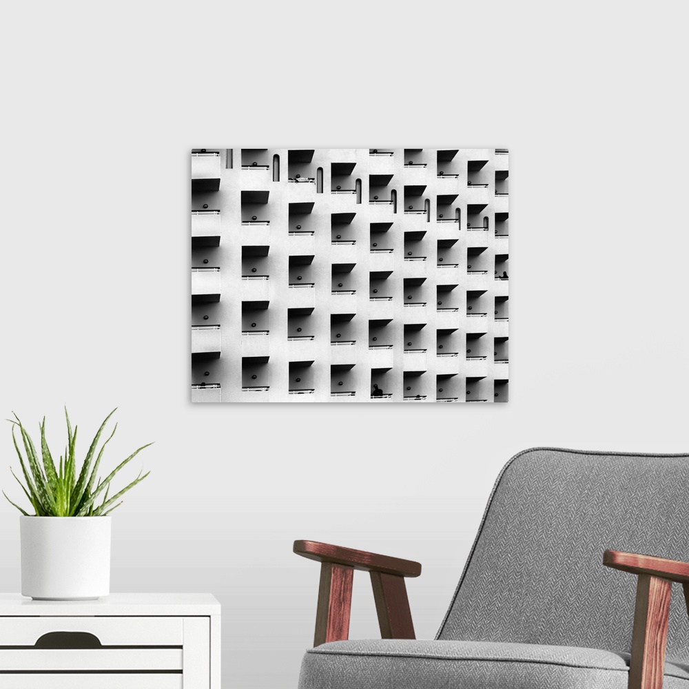 A modern room featuring Black and white architectural abstract photograph of a facade full of balconies.