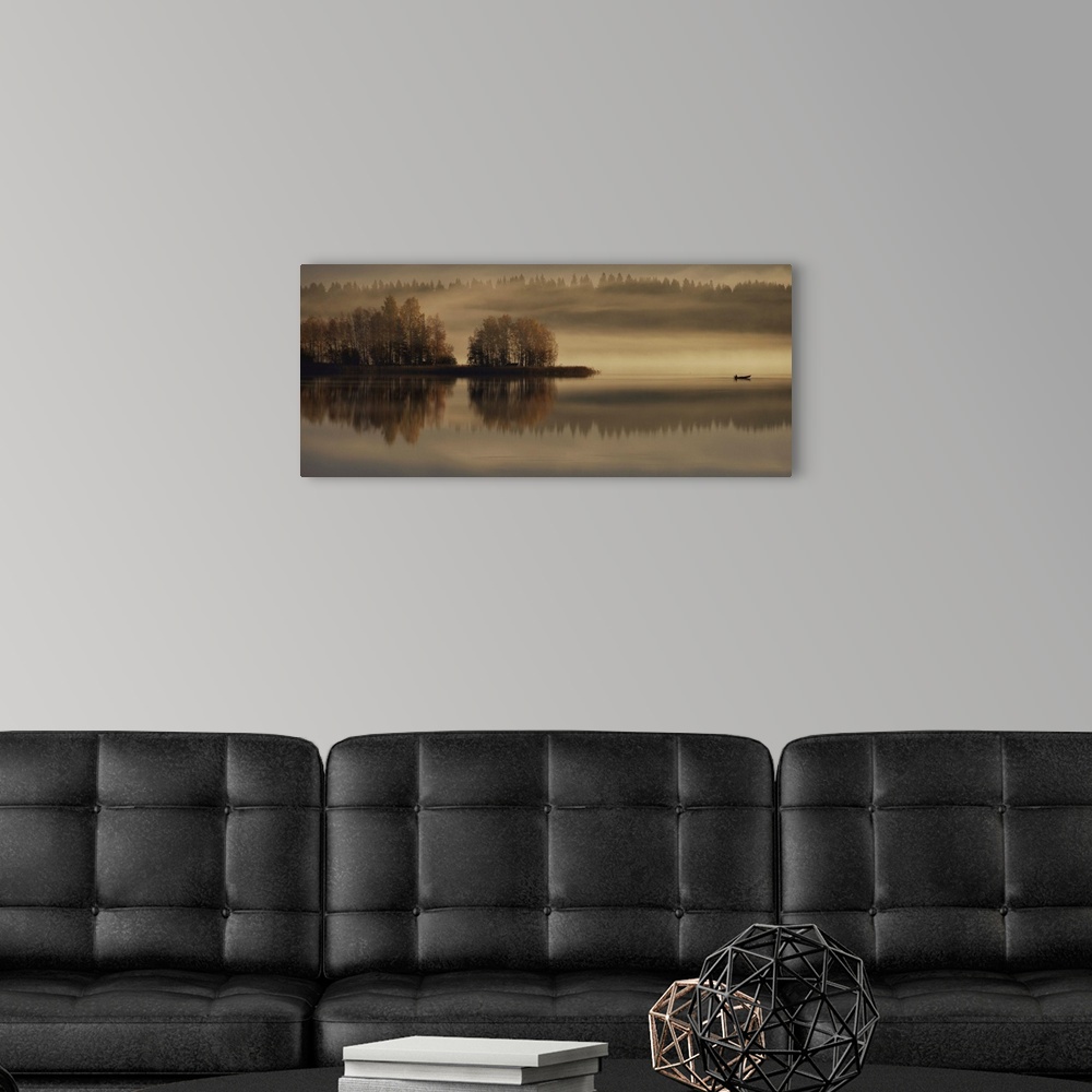 A modern room featuring A photograph of an early autumn morning scene in the countryside, with fog hovering above the gro...