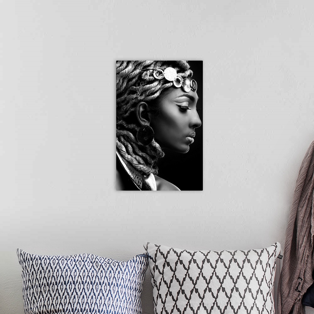 A bohemian room featuring A black and white portrait of a woman in profile with an elaborate headdress.