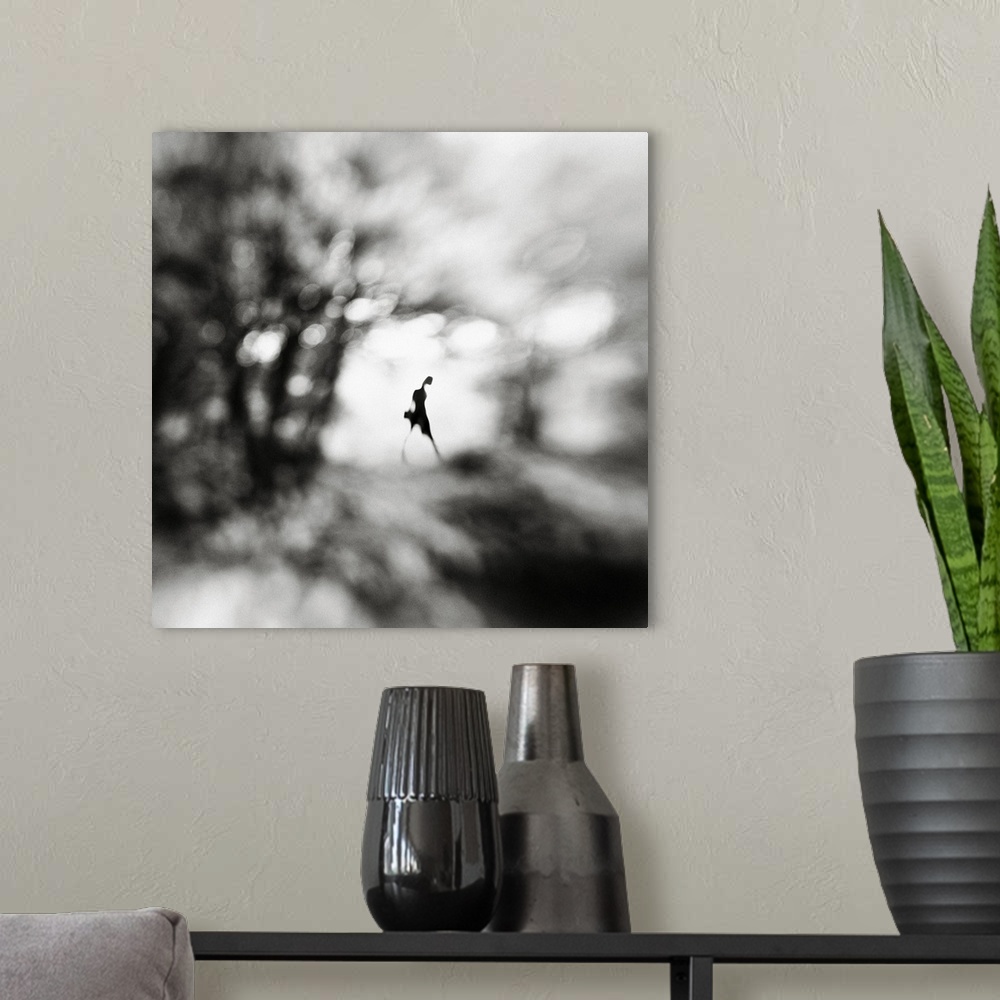 A modern room featuring Conceptual image of a figure walking in a blurred landscape.