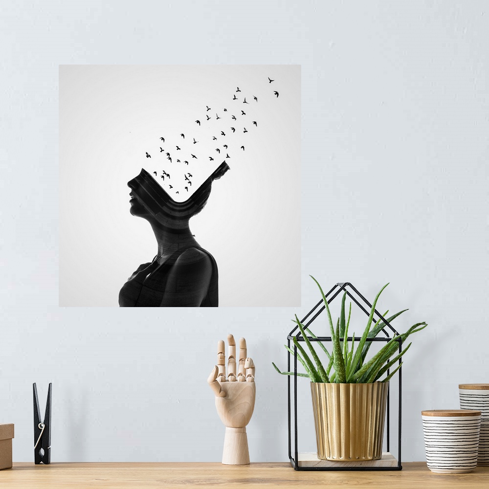 A bohemian room featuring A conceptual photograph of a profile of a woman with birds flying from her head.