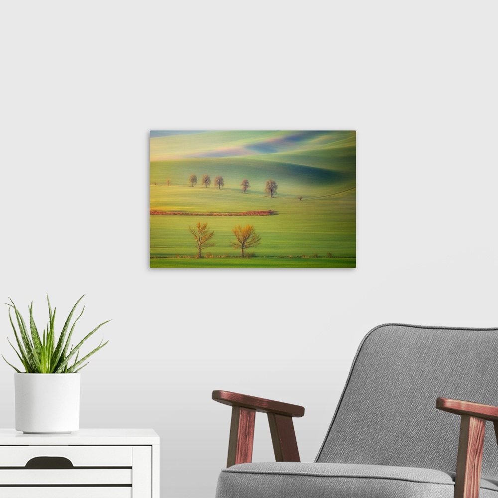 A modern room featuring Early morning view of the lush green fields on the hills in Tuscany.