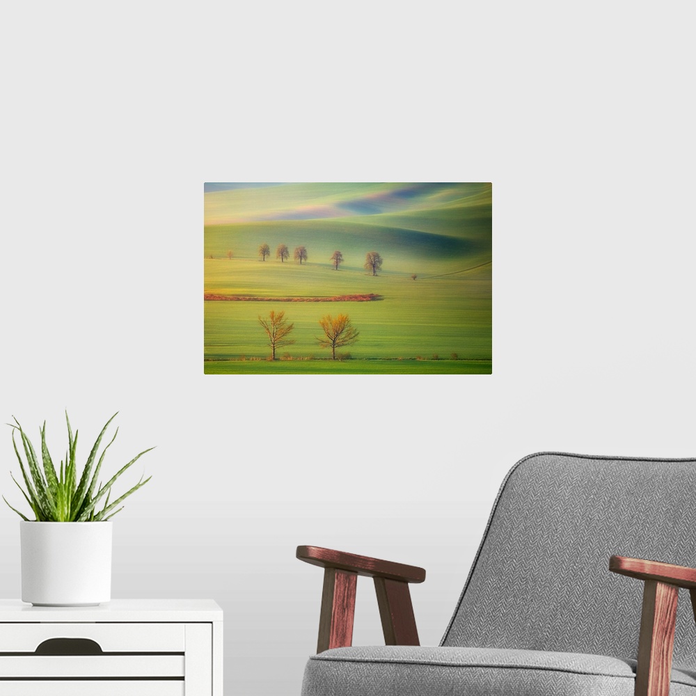 A modern room featuring Early morning view of the lush green fields on the hills in Tuscany.