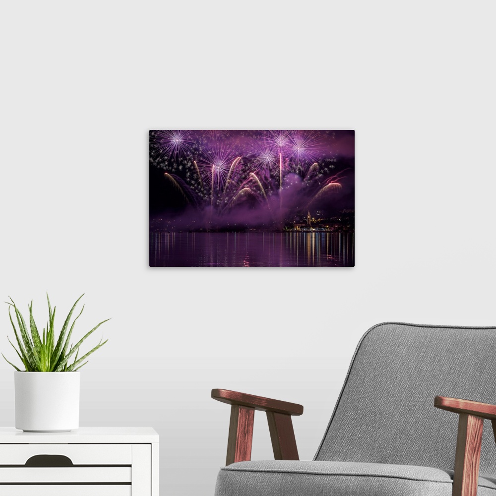 A modern room featuring Purple fireworks fill the sky over Como, Italy.