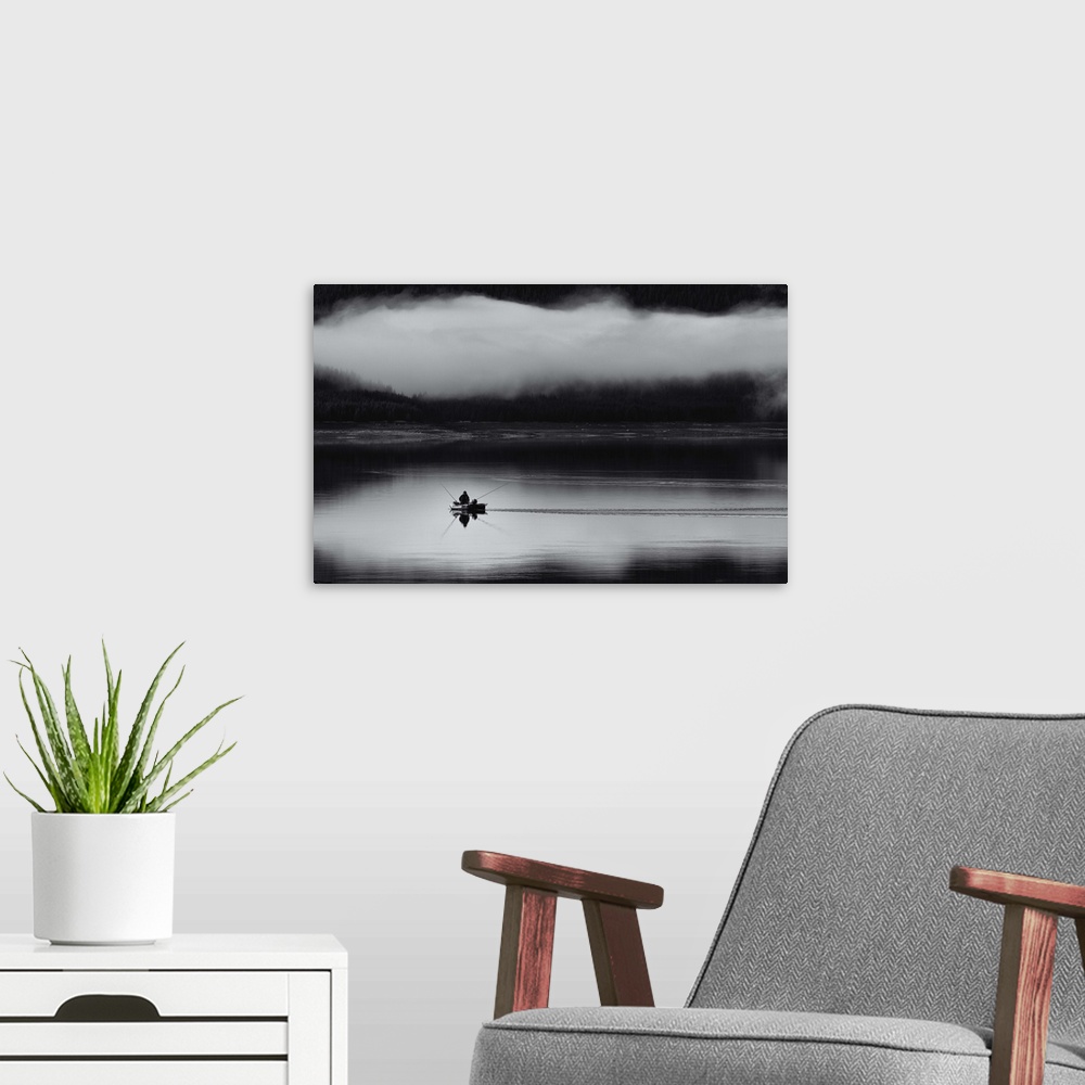 A modern room featuring Fishing on a lake with a thick cloud of fog hovering over a forest.