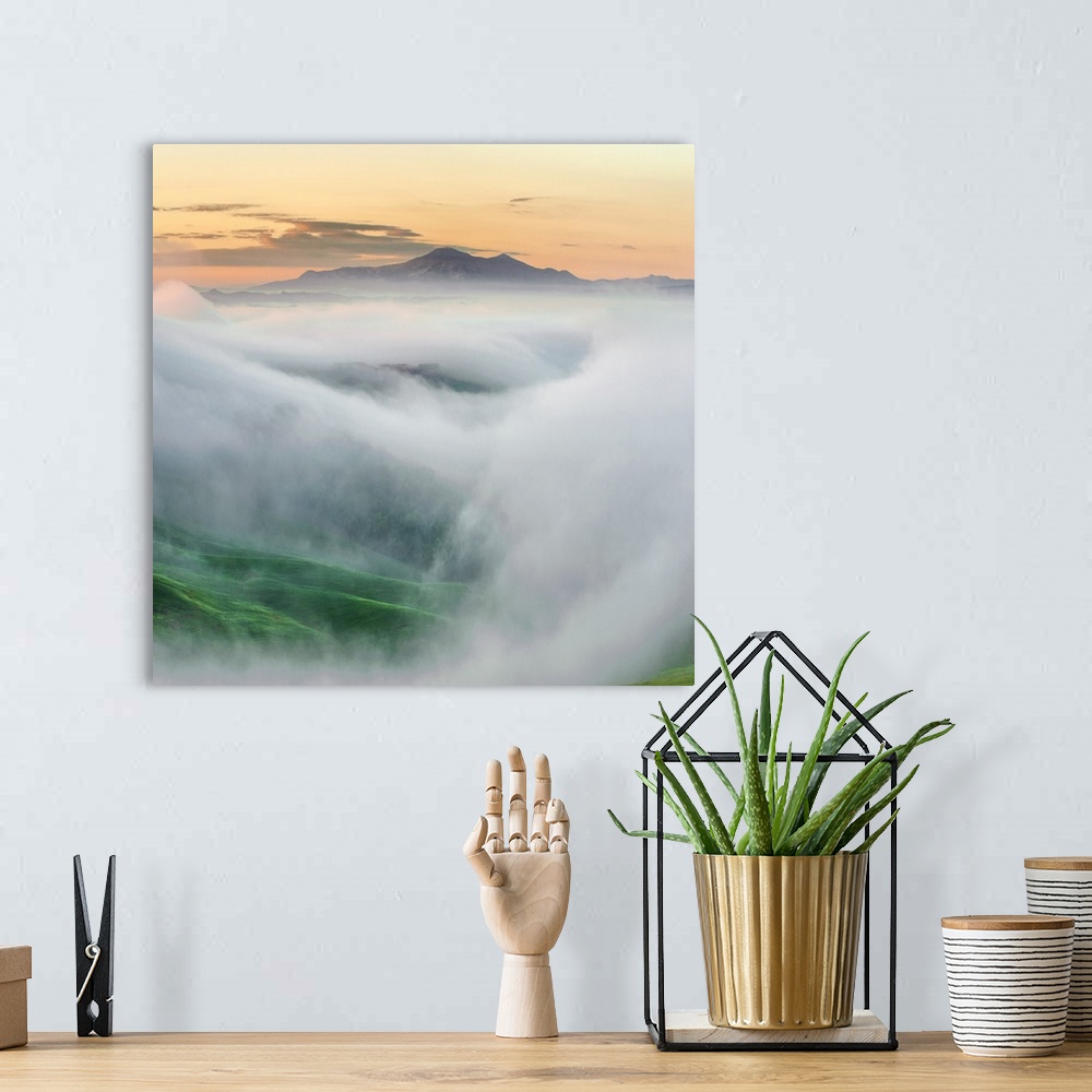 A bohemian room featuring Photo showing the top of the mountain surrounded by mists.