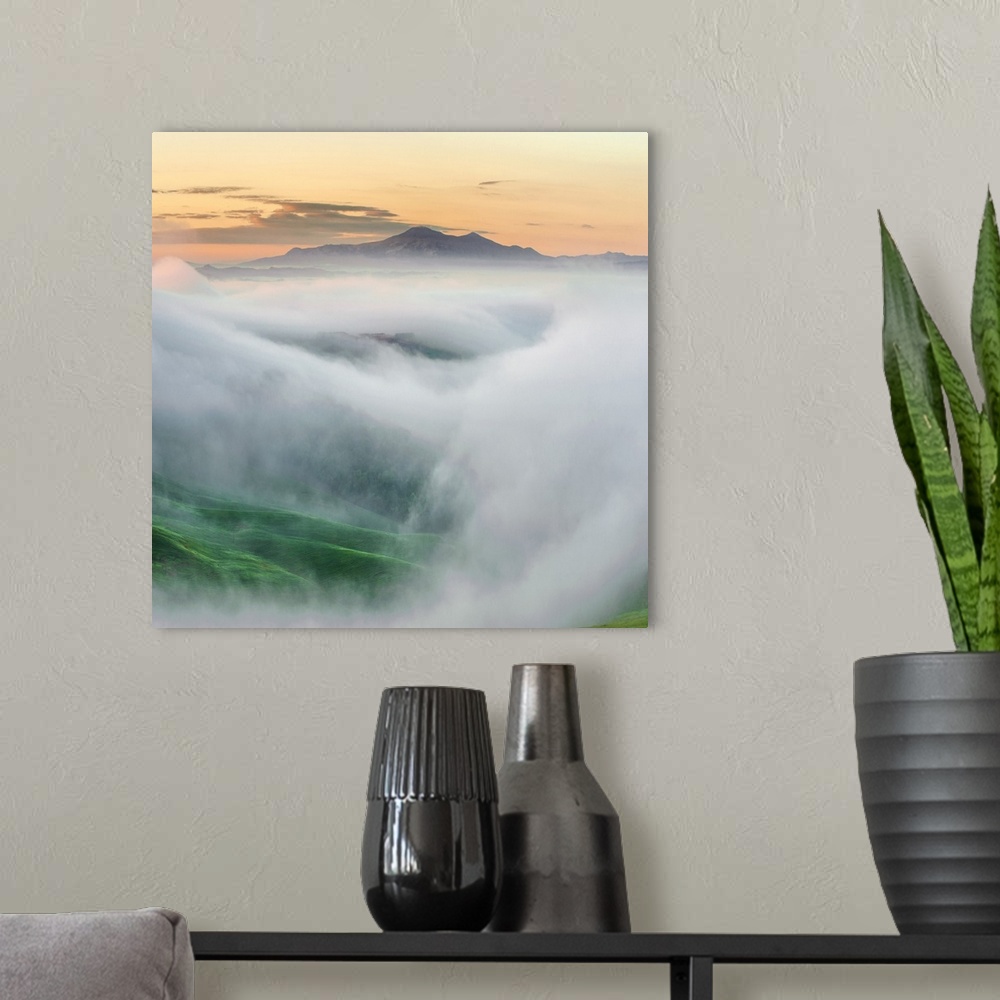 A modern room featuring Photo showing the top of the mountain surrounded by mists.