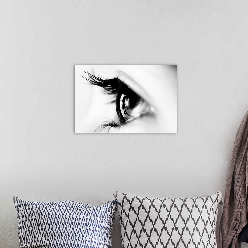 A bohemian room featuring Close up image of a human eye with thick eyelashes.