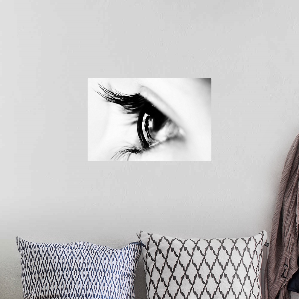 A bohemian room featuring Close up image of a human eye with thick eyelashes.