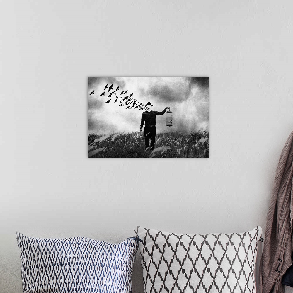 A bohemian room featuring Conceptual photograph of a man standing in a field holding a bird cage with his face dematerializ...