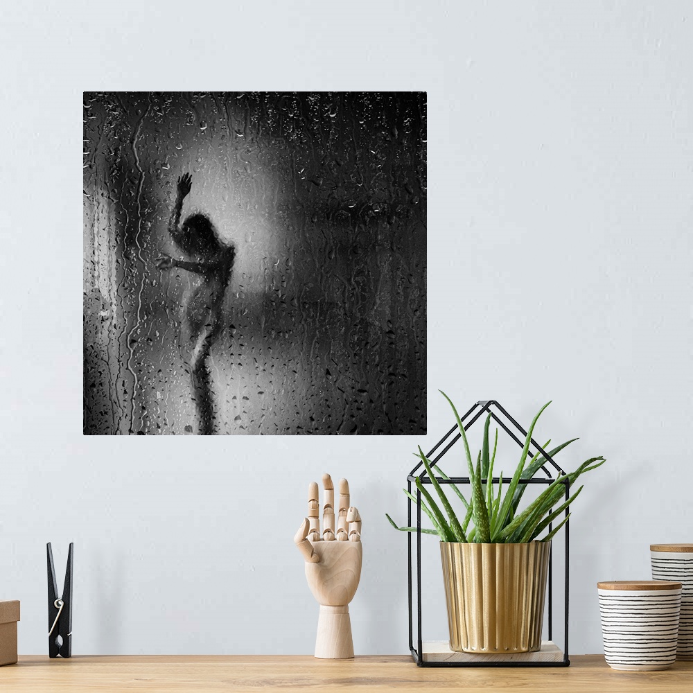 A bohemian room featuring Square black and white fine art photograph of a nude woman through a rainy window glass.