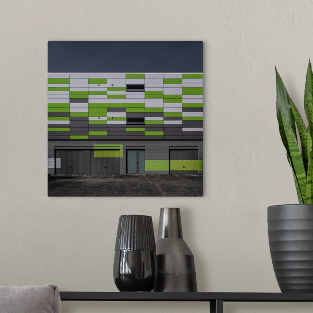 A modern room featuring Green and white panels on the side of a building creating an interesting artistic effect.