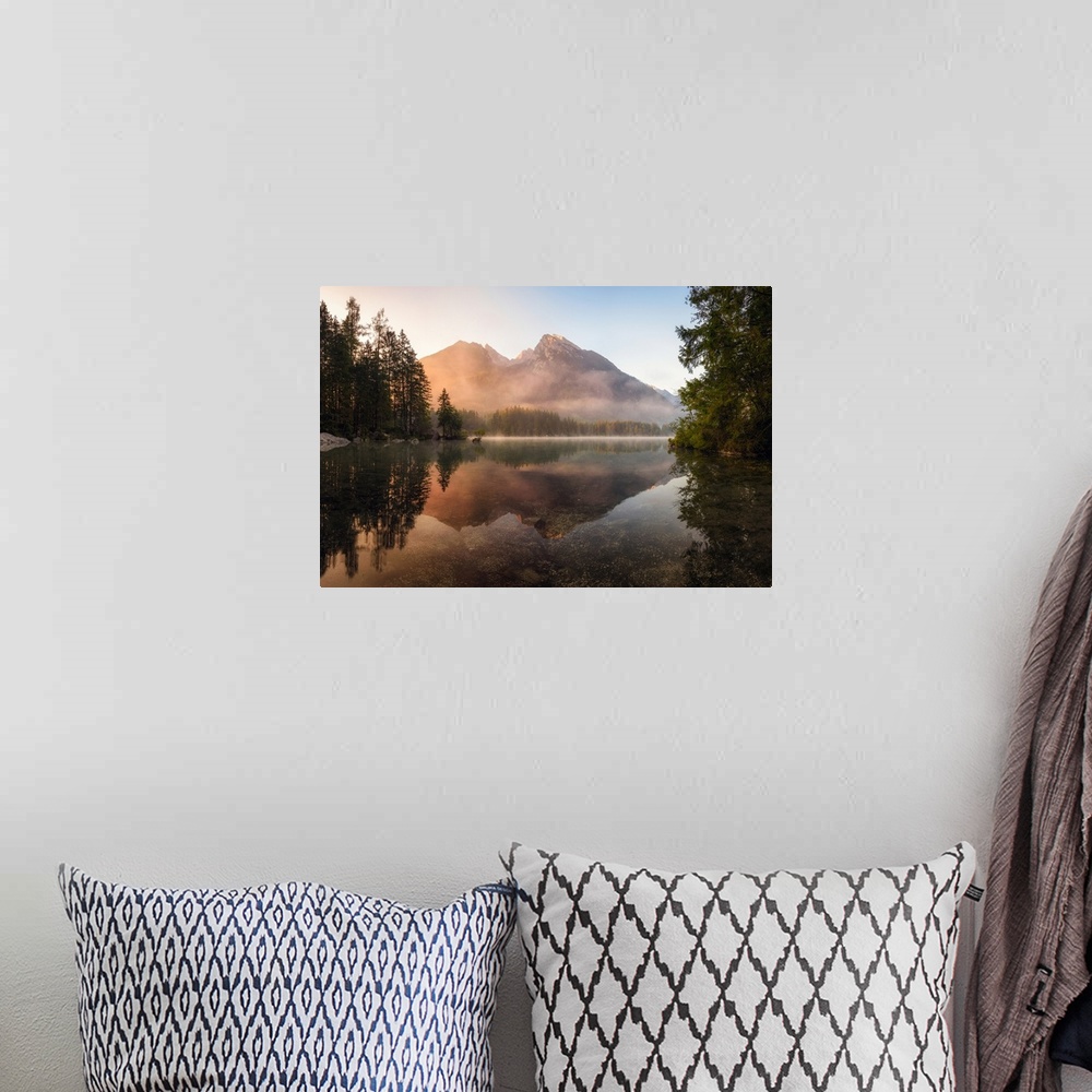 A bohemian room featuring Reflective landscape photograph on a lake with trees and mountains in the background at sunrise.
