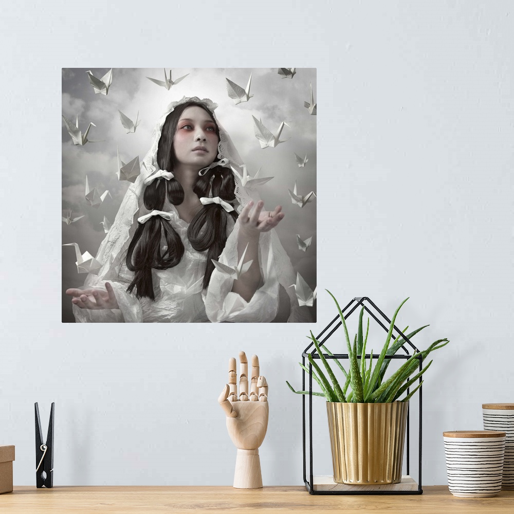 A bohemian room featuring Conceptual image of a beautiful woman in a white robe with paper cranes floating around her.