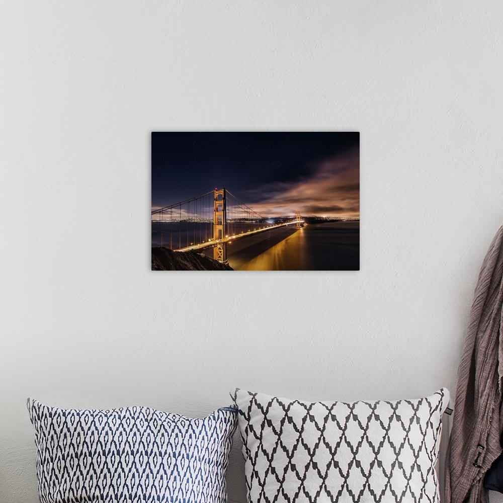 A bohemian room featuring Photograph of the Golden Gate Bridge lit up at night.