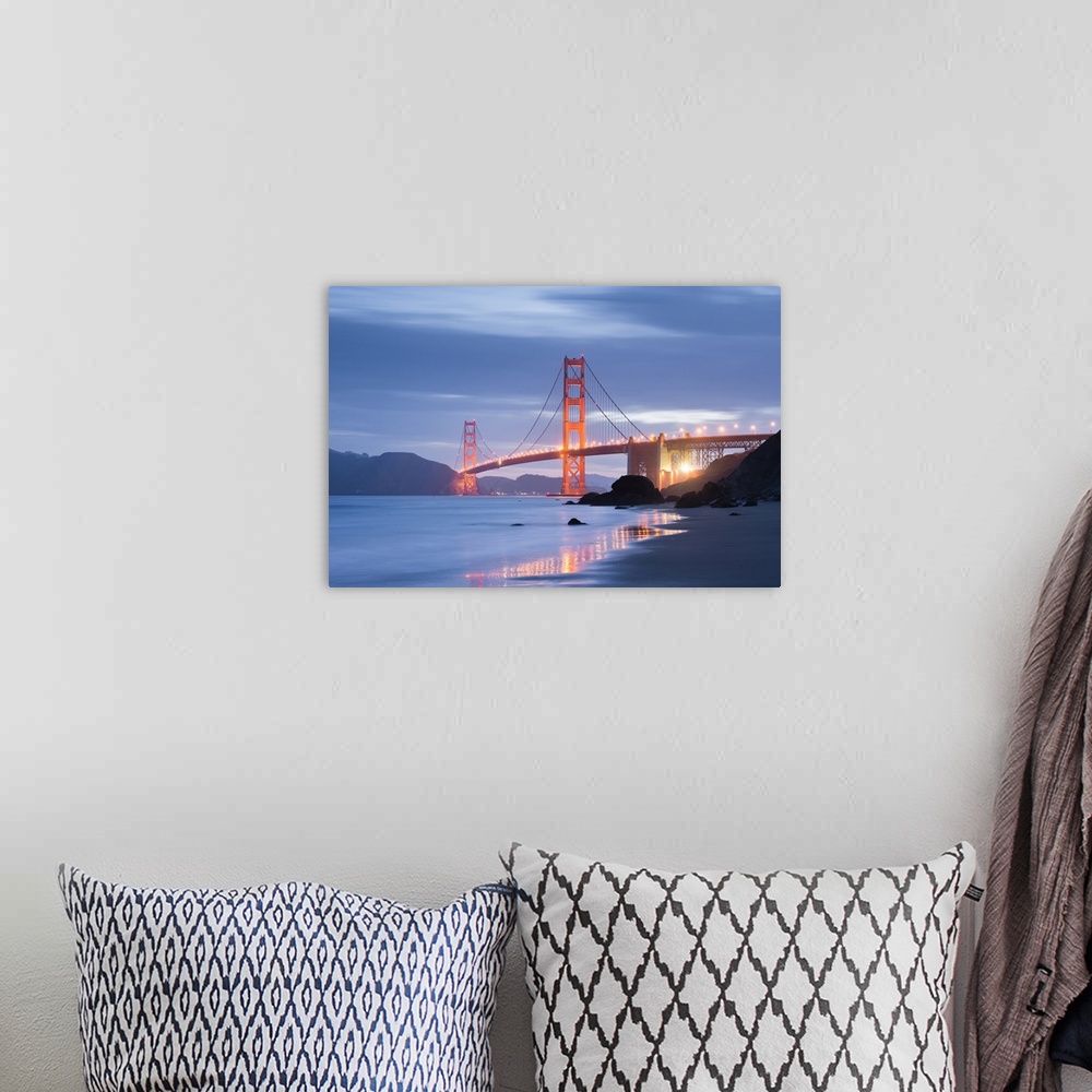 A bohemian room featuring A soft and dreamy photograph of the golden gate bridge in San Francisco lit up in the early evening