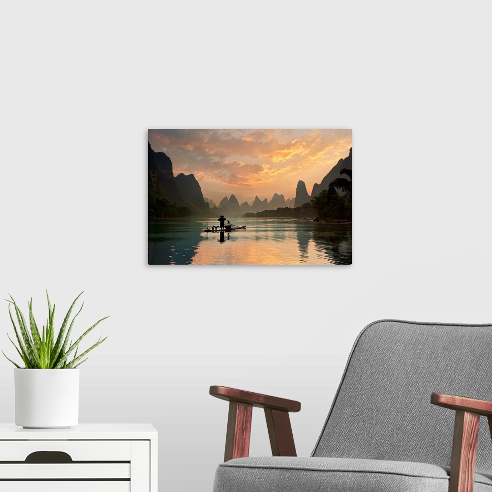 A modern room featuring A fisherman and his cormorants on a boat in the Li River at dawn, China.
